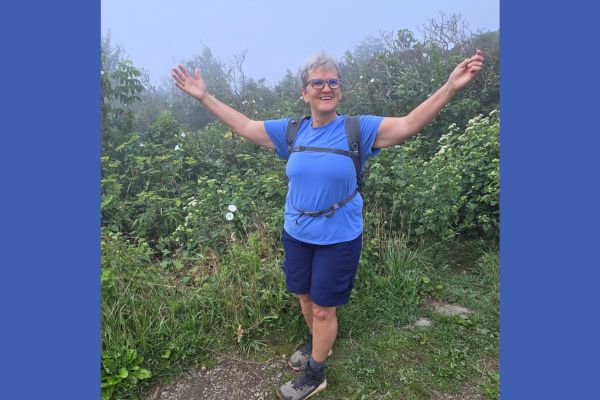 Claudette walking along a wooded trail, representing the intentional choices involved in rebuilding health, calm, and strength naturally.