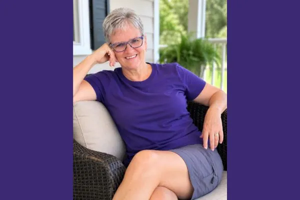 Claudette Eames relaxing on a porch, representing the freedom created by building better business systems.