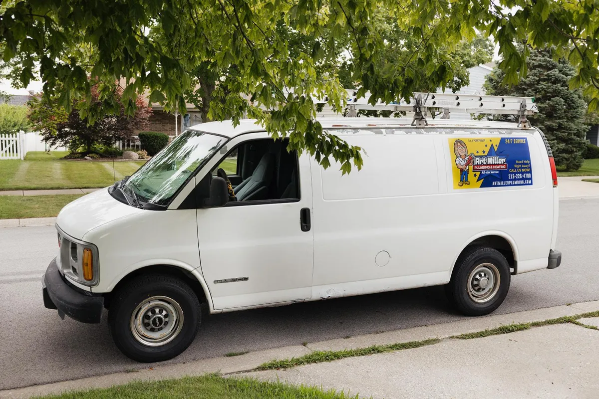 Plumbing van in front of residential home.