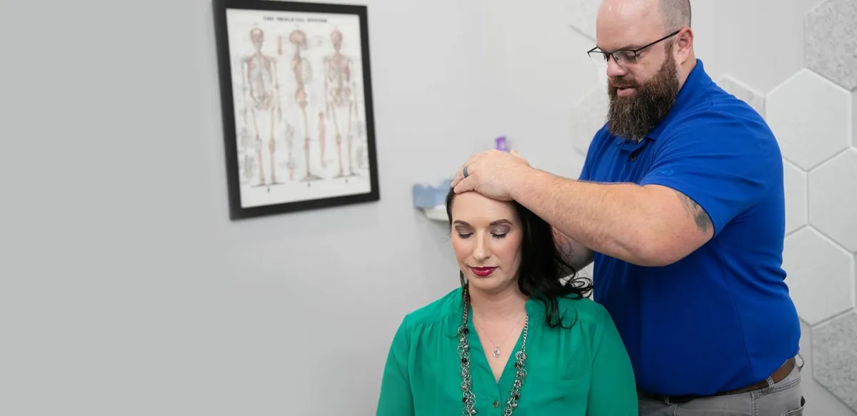 Chiropractor performing spinal adjustment at Absolute Wellness in Peoria