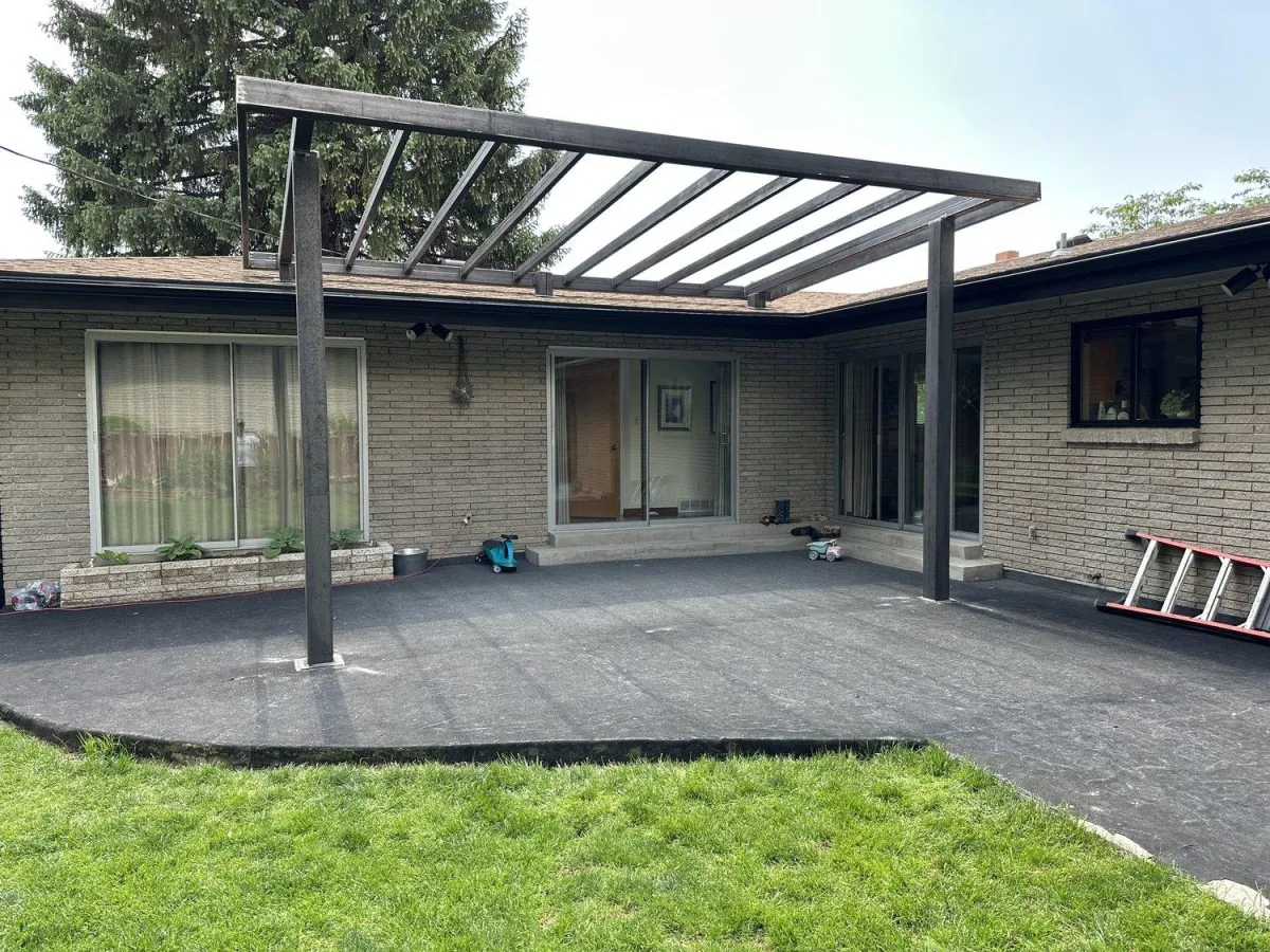 Custom metal pergola in the backyard of a home