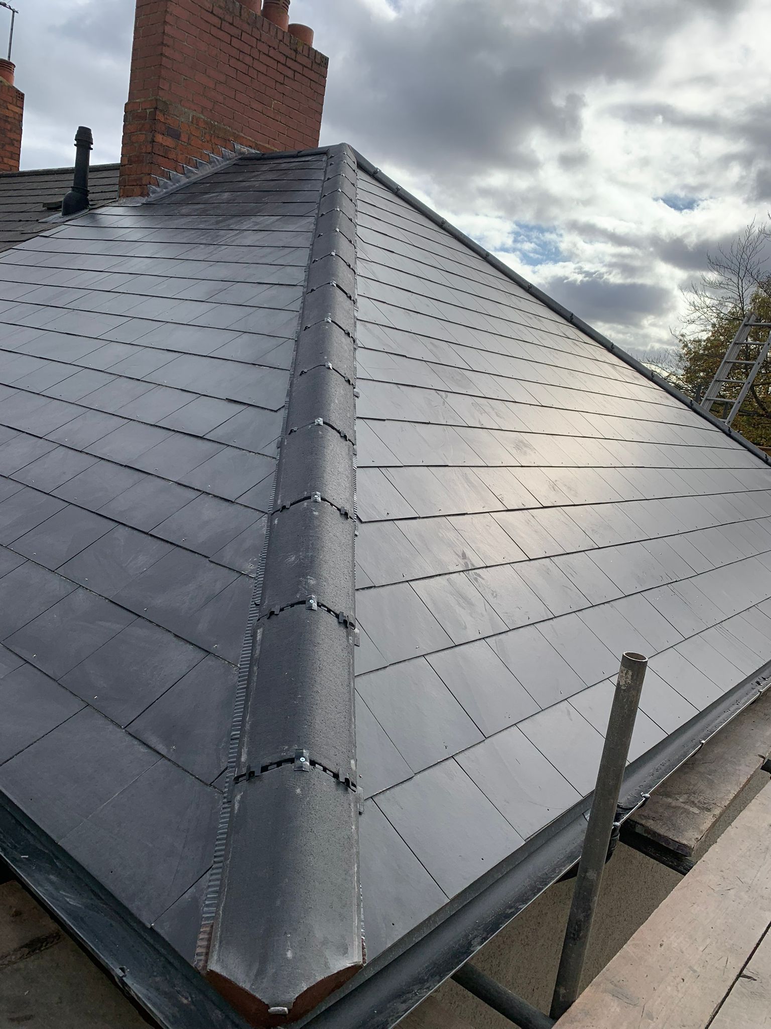 Natural slate roof installation with lead flashing details