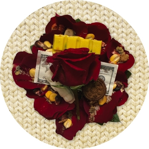 Andean despacho offering with rose petals, corn, seeds, and symbolic offerings
