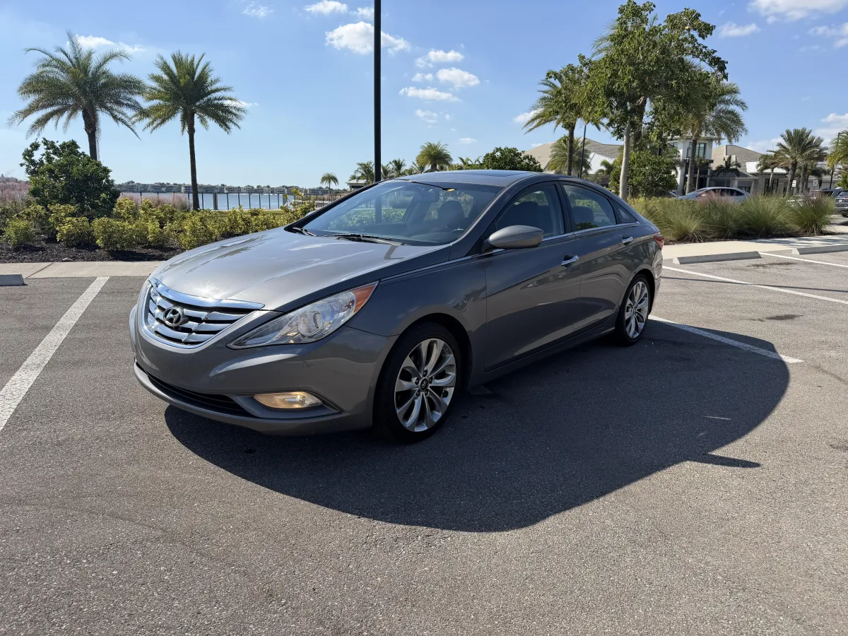 Hyundai Sonata rental car parked at Fort Myers airport delivery location