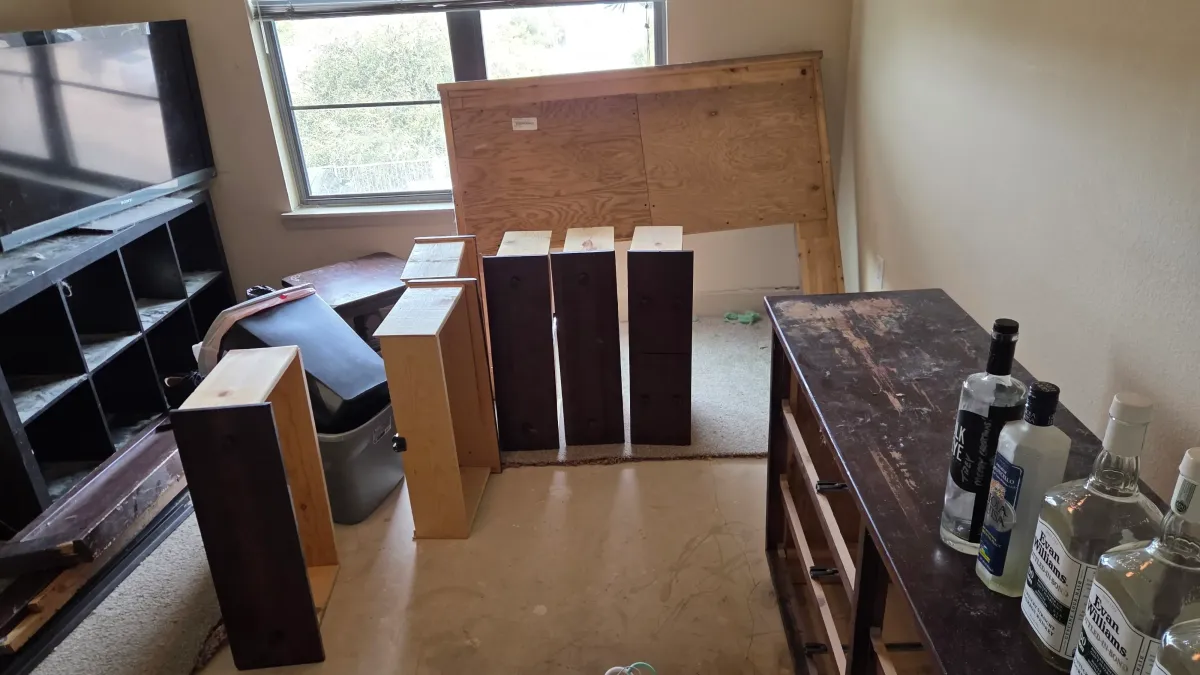 Apartment junk removal with furniture and bottles.