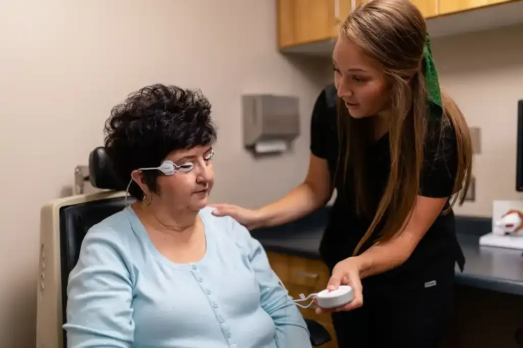 Optometrist examining a patient's eyes at Eyes in Disguise, highlighting personalized vision care services in San Francisco.