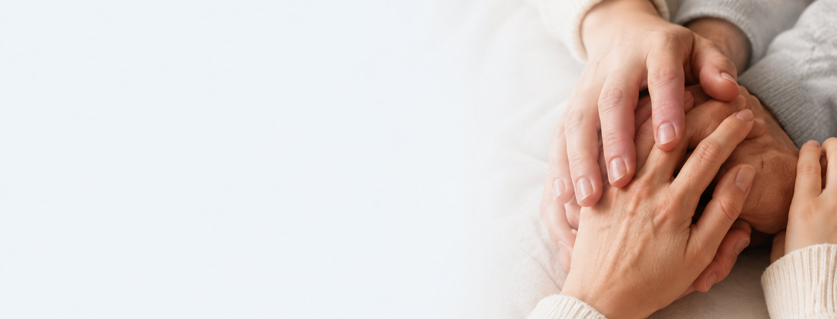 Caring hands holding a client's hands