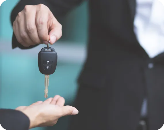 Hand holding car key symbolizing LH3 pick-up and drop-off concierge service"