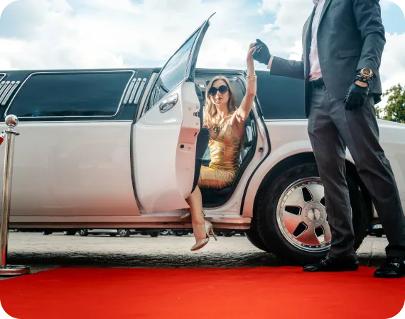 Customer stepping out of luxury car at dealership, LH3 red carpet vehicle purchase experience"