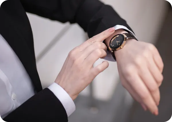 Close-up of businessman checking watch symbolizing LH3 punctual and reliable airport transfers"