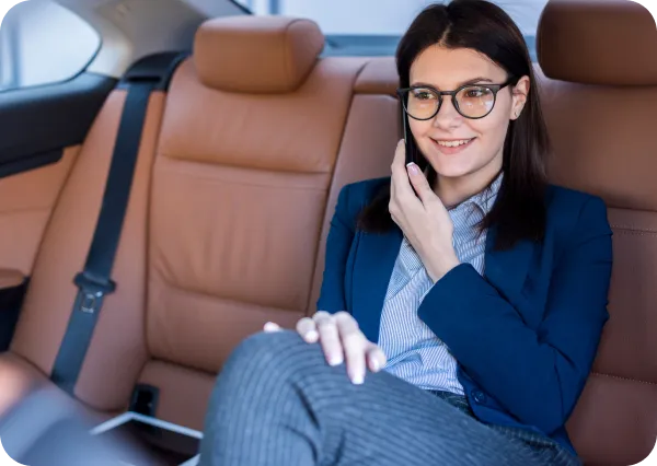 Businesswoman sitting comfortably in luxury car seat, symbolizing LH3 premium airport travel comfort"