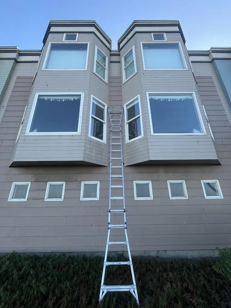Professional window cleaning three-story residential home ladder setup Solano County Teodor Window Solar Cleaning