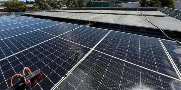 Professional solar panel cleaning service technician cleaning rooftop solar array Solano County Teodor Window Solar