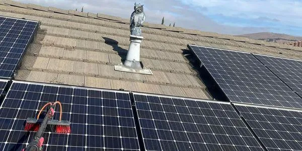 Solar panel cleaning technician on residential roof purified water system Solano County Teodor Window Solar Cleaning