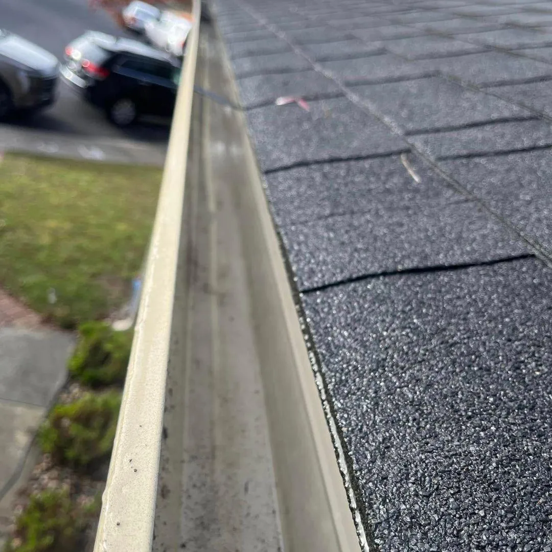 Clean residential gutter preventing water damage roof edge Solano County professional gutter cleaning service