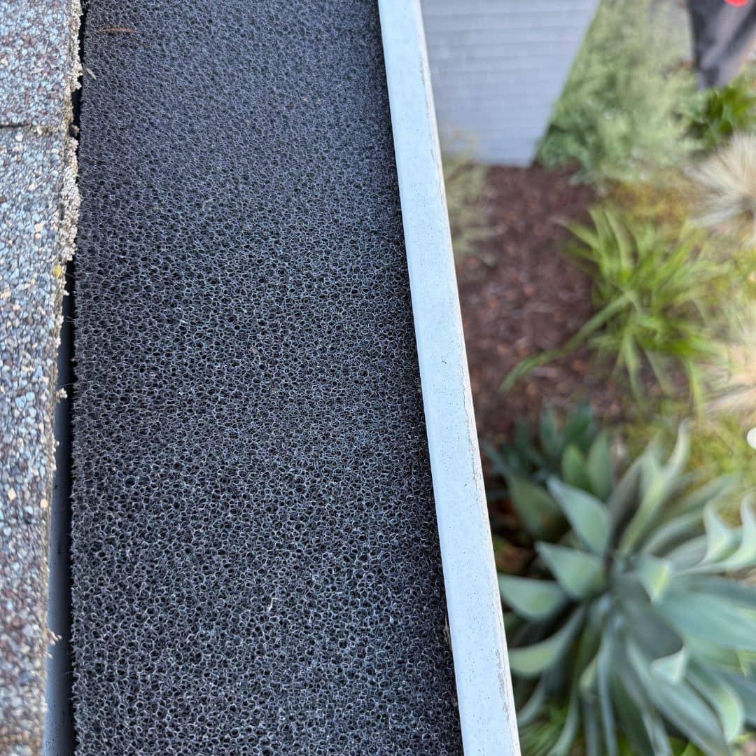 Gutter guard mesh installation close-up debris protection residential Solano County Teodor Window Solar Cleaning