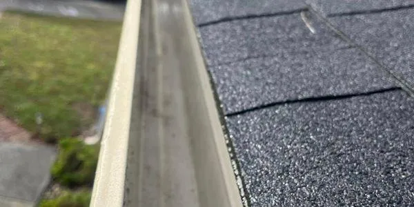 Clean residential gutter preventing water damage roof edge Solano County professional gutter cleaning service