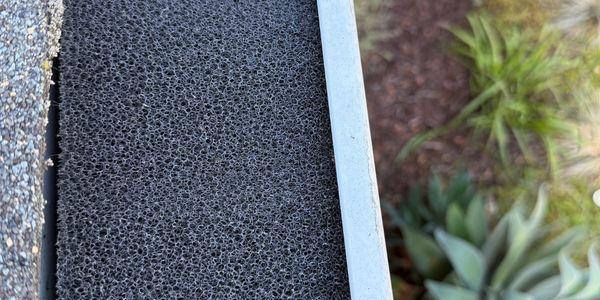 Gutter guard mesh installation close-up debris protection residential Solano County Teodor Window Solar Cleaning