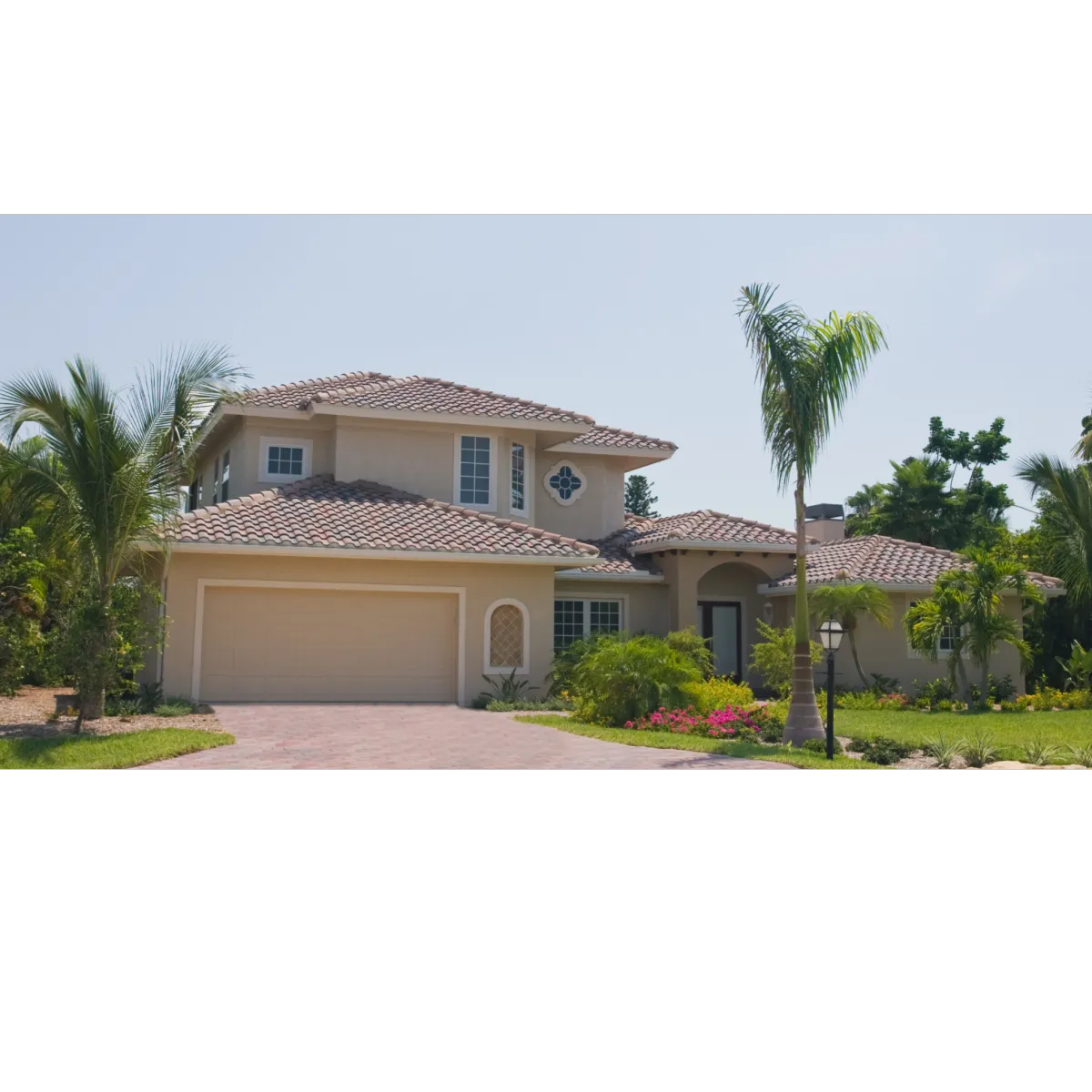 Florida home with with two palm trees and tan stucco