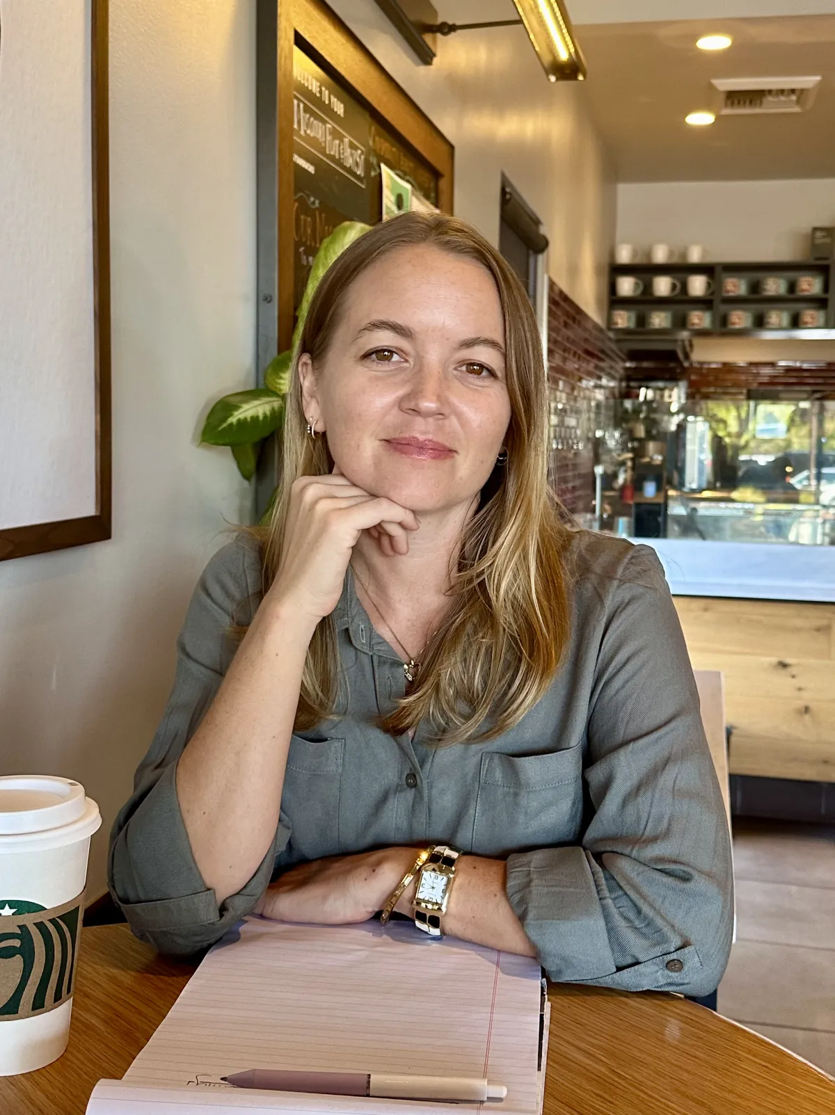 Friendly business coach smiling and talking with a small business owner