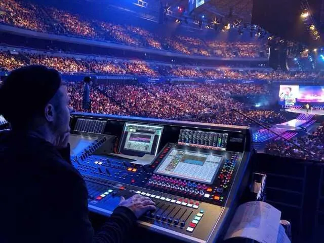 Sound engineer at mixing console during church event