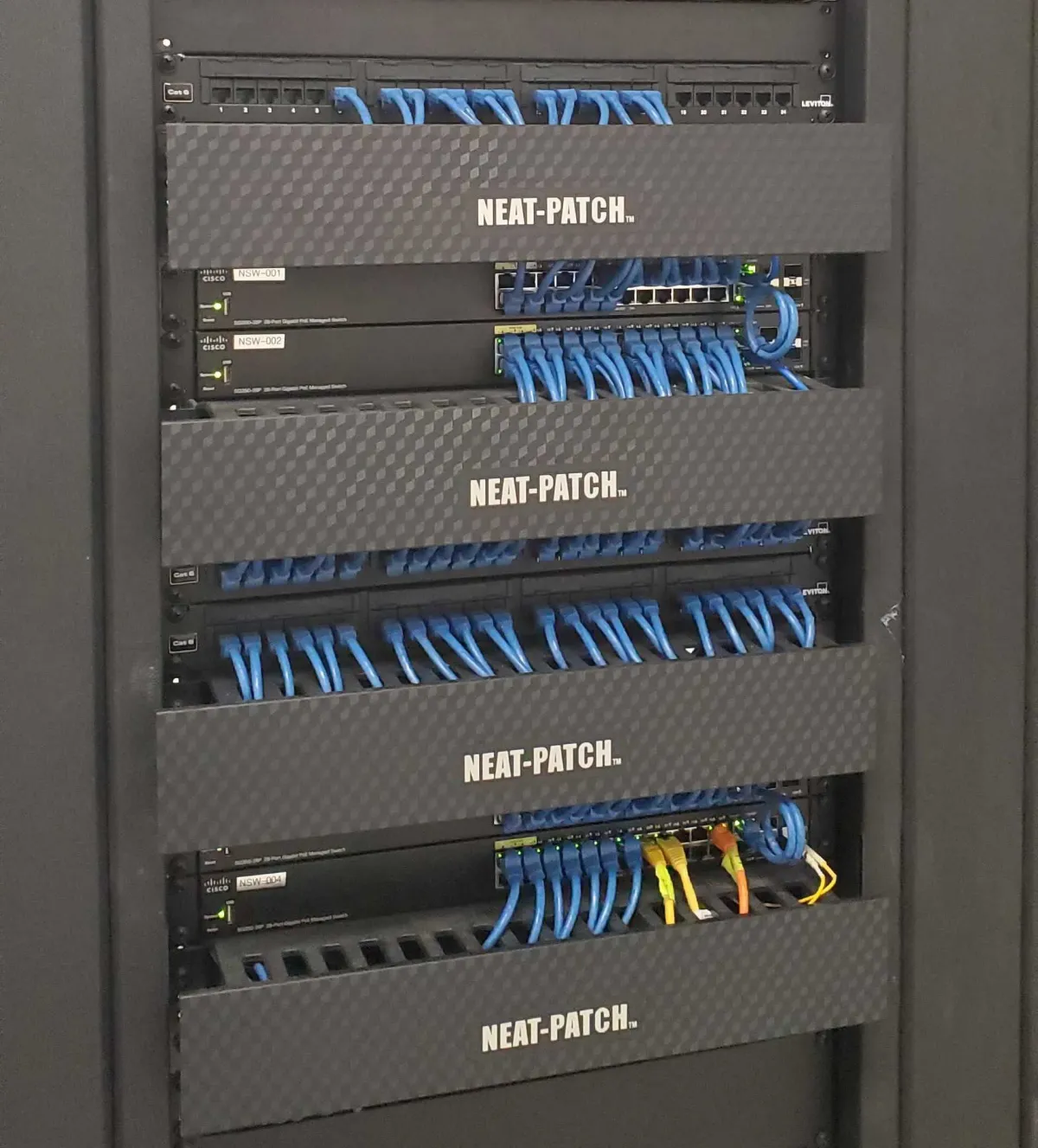 Network server rack with neatly organized blue ethernet cables using Neat-Patch cable management system for professional IT and AV installations.