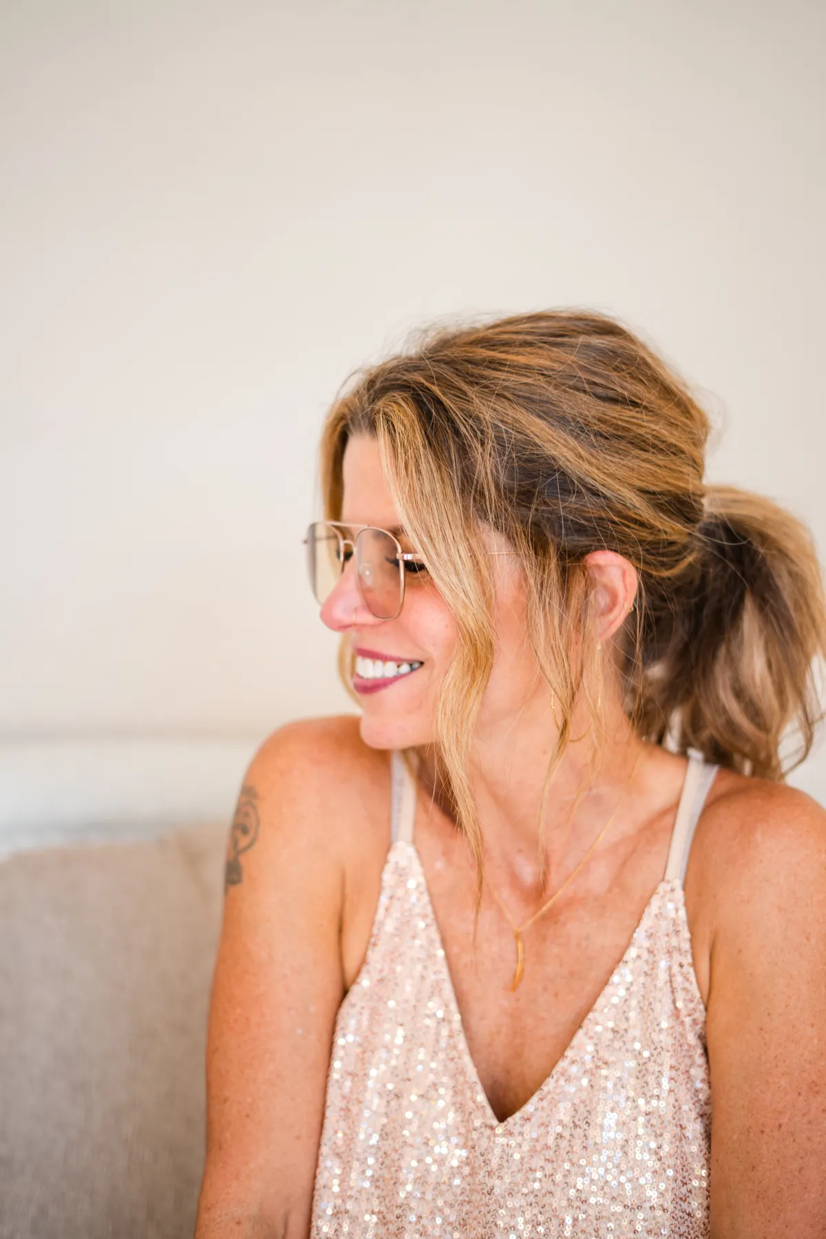 Mindi Huebner, glasses gold tank, smiling