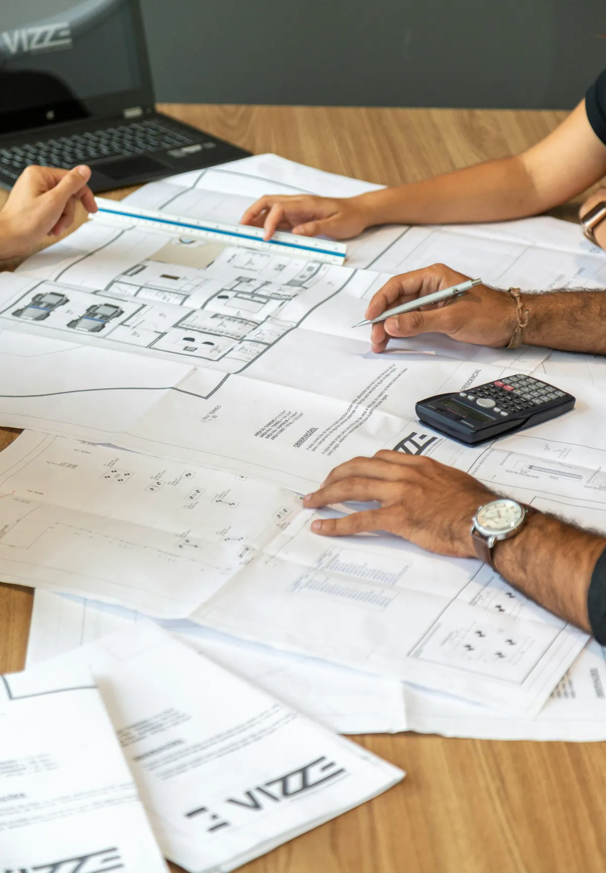 Contractor reviewing project drawings and specifications at a desk