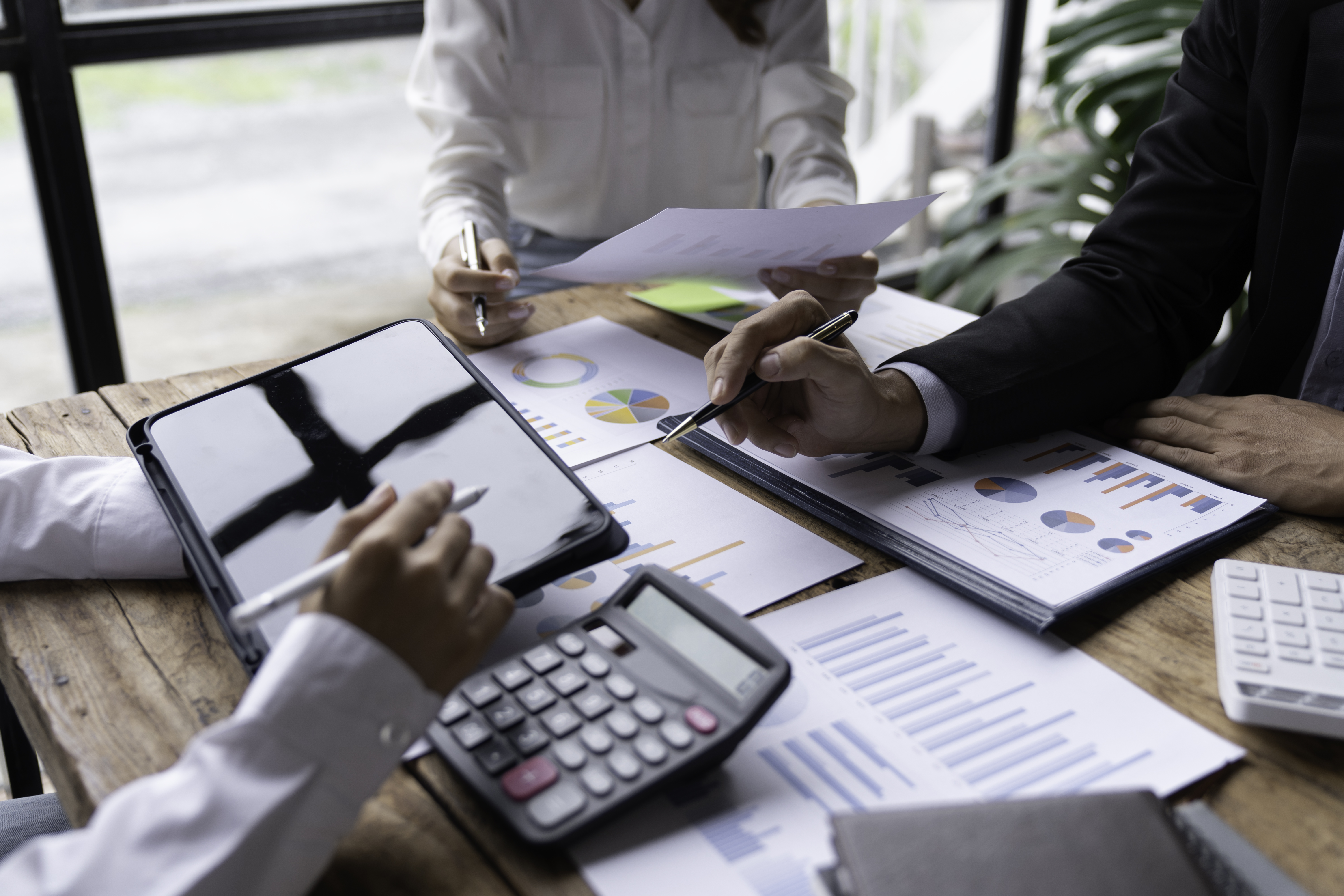 Trader analyzing stock market data on smartphone and phone
