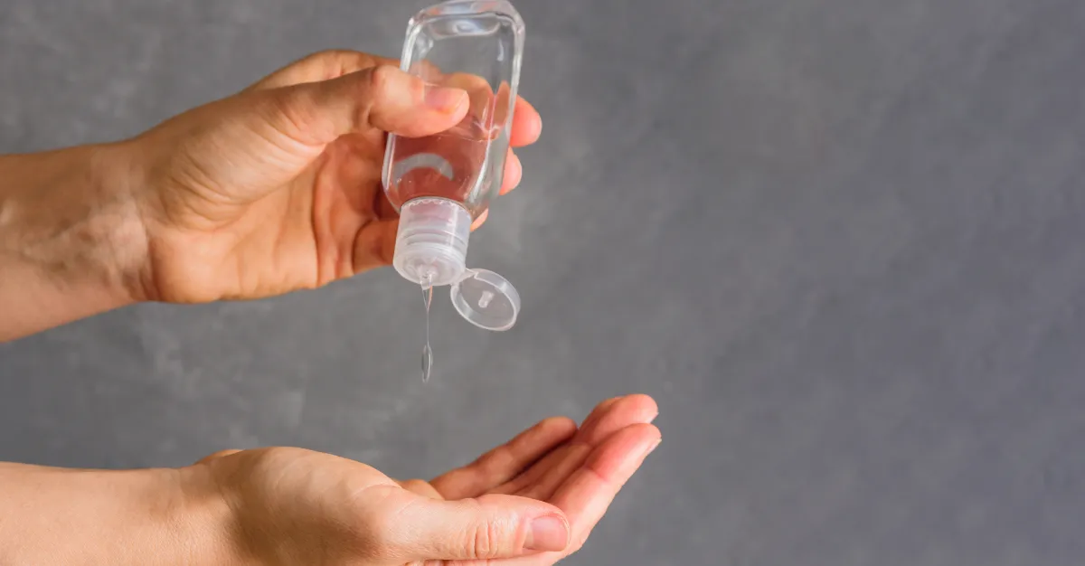 hands holding and using sanitizer
