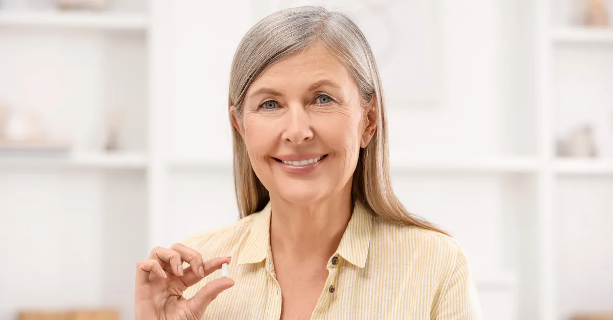 older woman with a pill