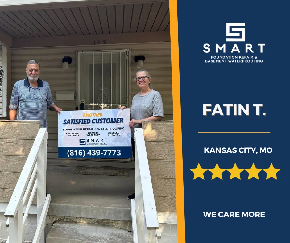 Fatin T. and another individual from Kansas City, MO standing on the porch of a house, holding a 'Satisfied Customer' sign, showcasing the excellence of SMART Foundation Repair & Basement Waterproofing services.