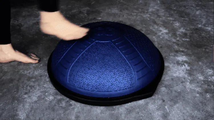 Course Feature, person balancing on an inflatable fitness device.