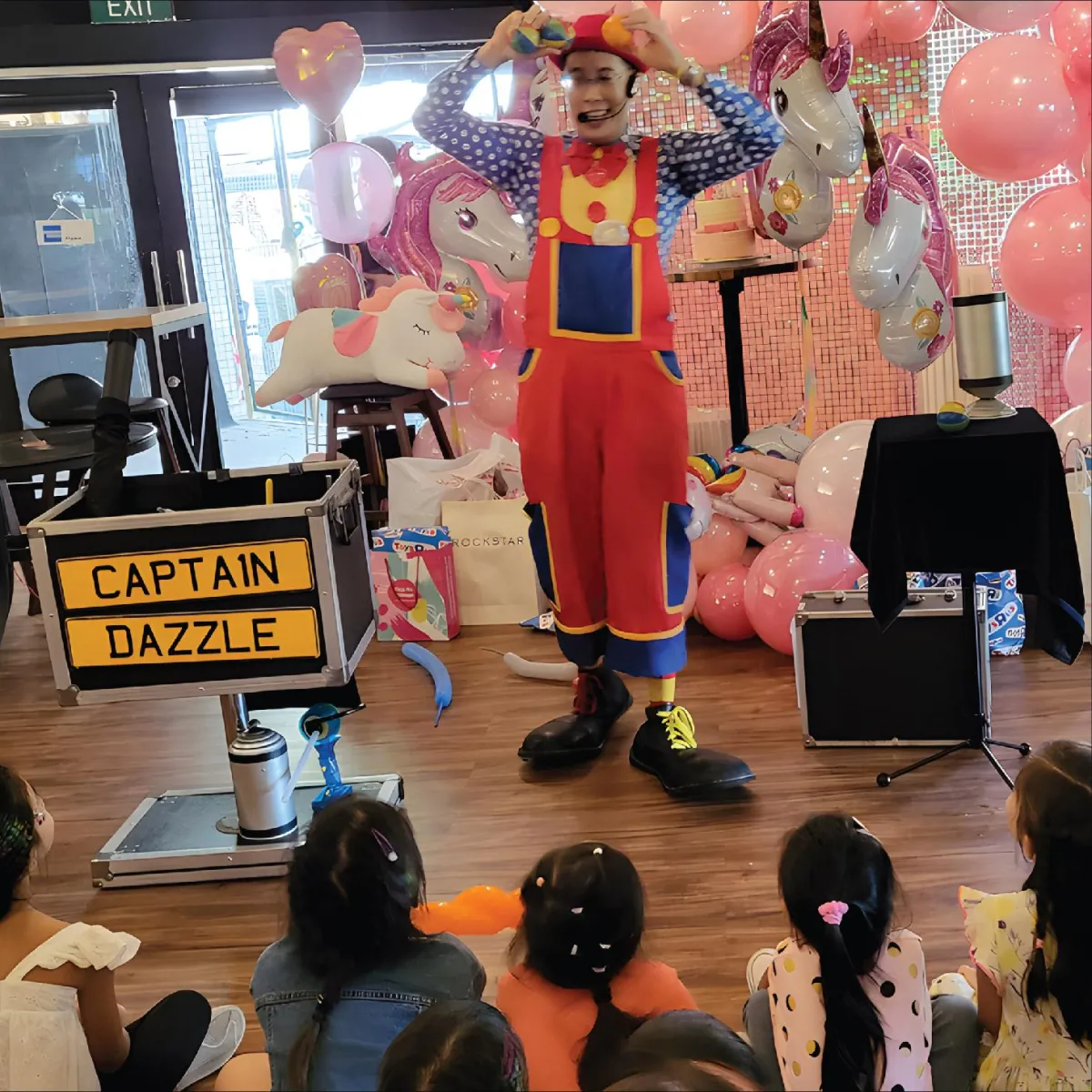 A clown performing for children at a celebration party hosted by R Italian Kitchen & Smokehouse.