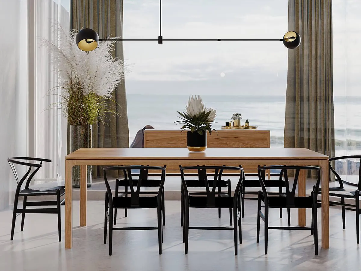 a timber blackwood dining table that has 8 black dining chairs