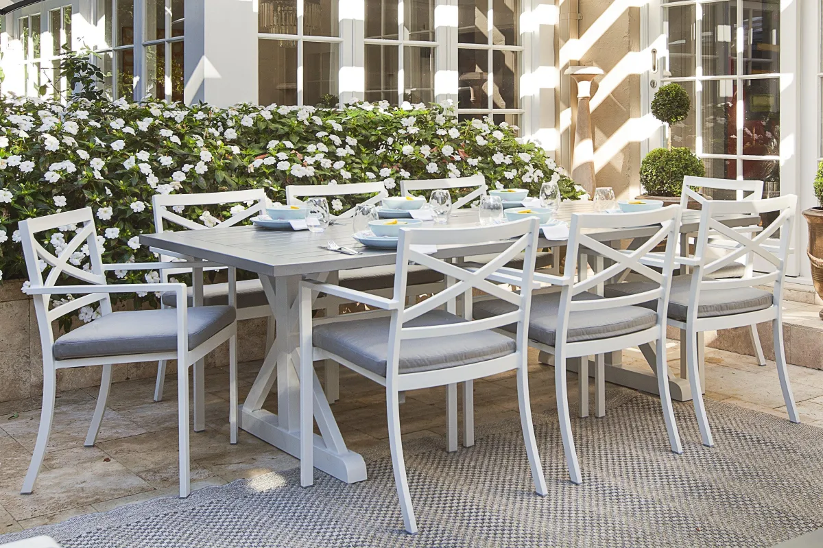 a white outdoor dining table with chairs