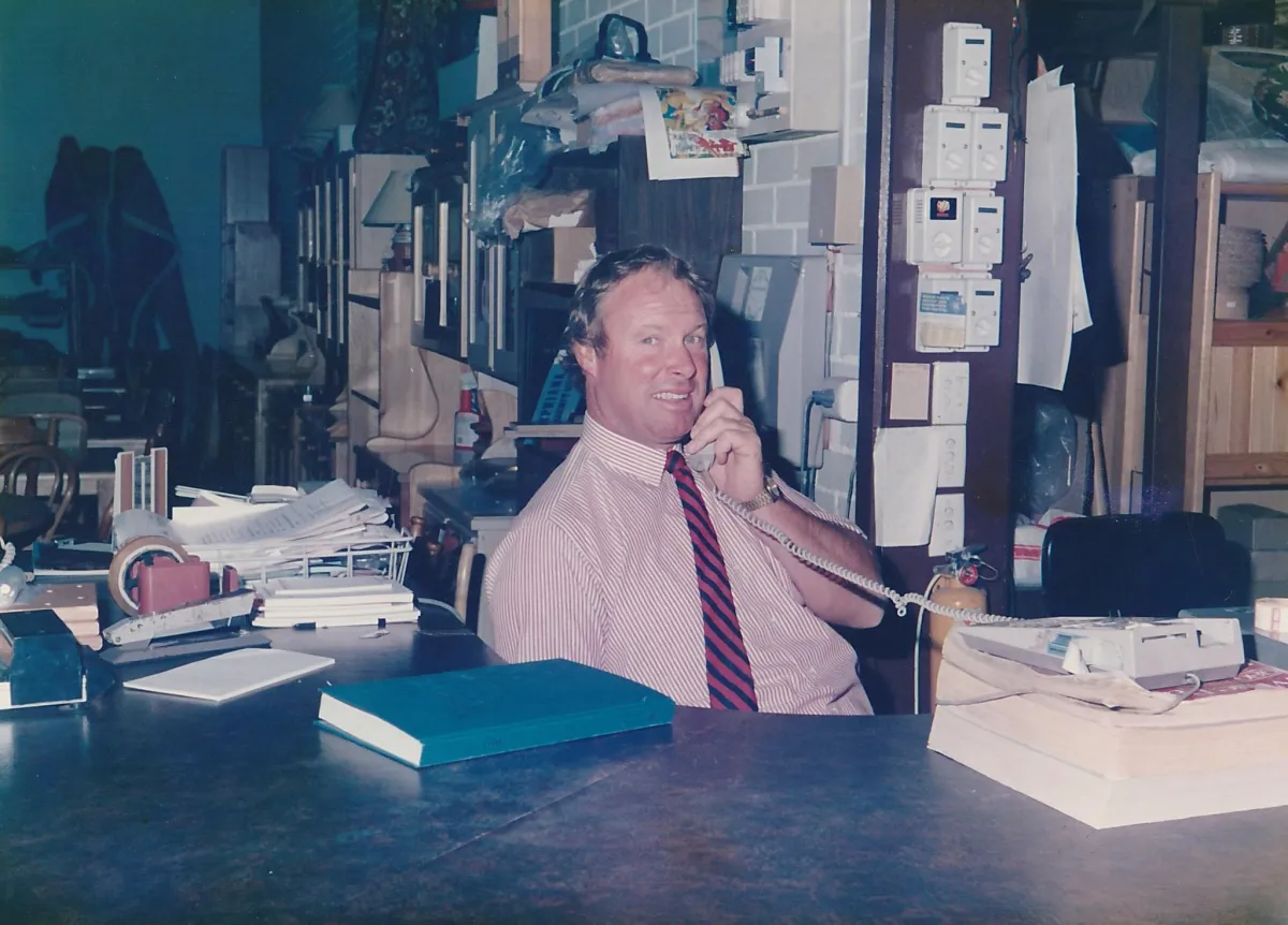 Rodney Webster founder, sitting at his desk