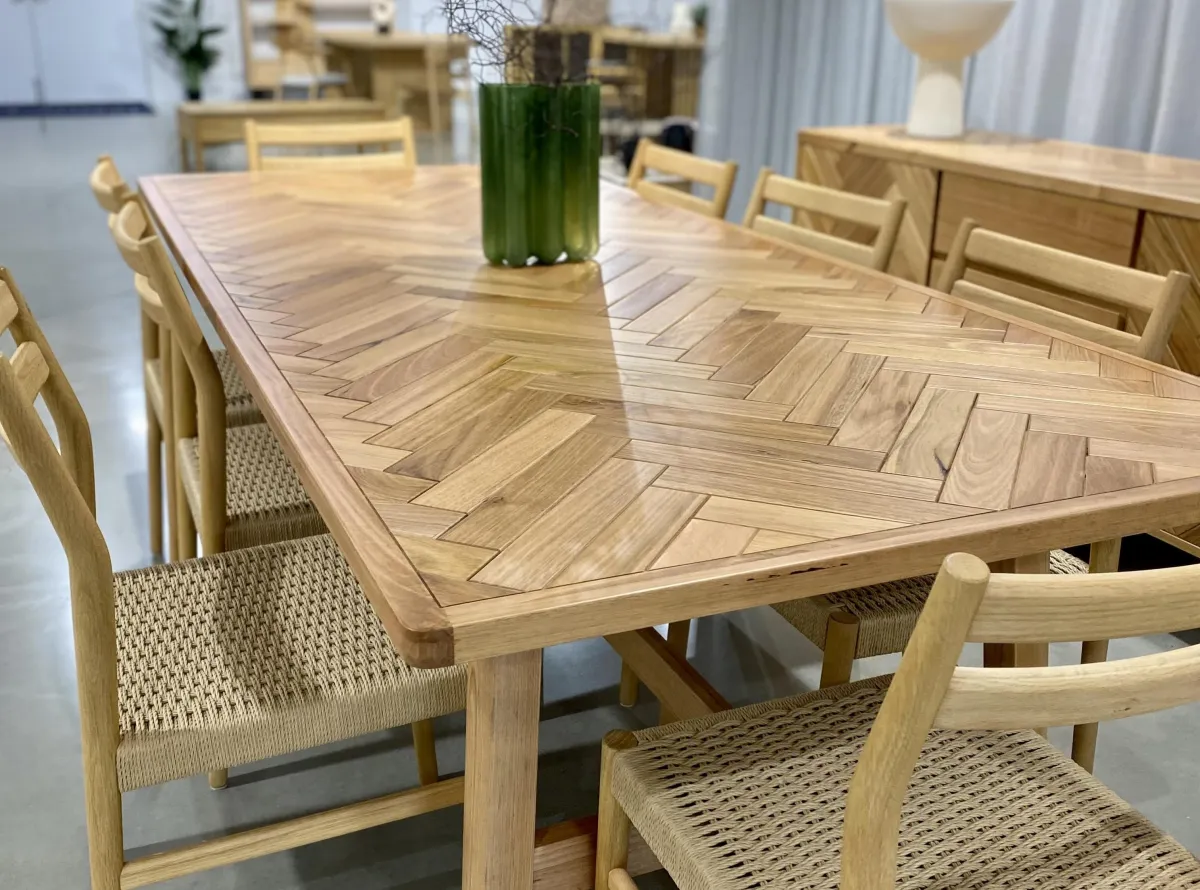 a 6 seater dining table with  timber top accompanied by 6 matching chairs