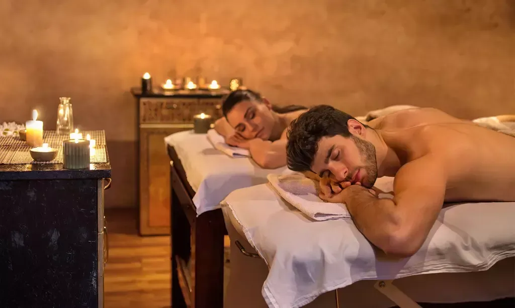 Licensed massage therapists performing couples massage in private room