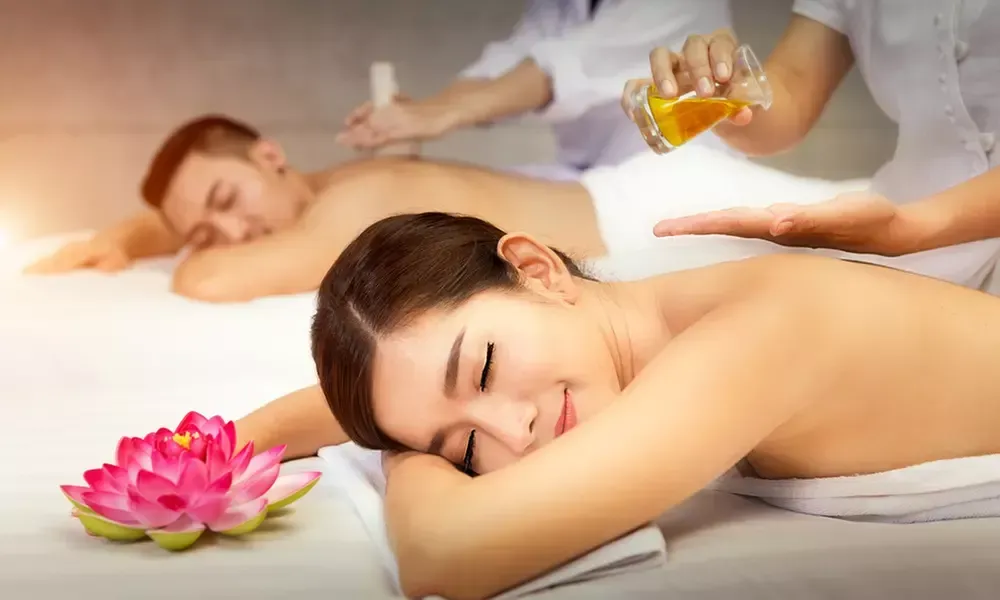 Relaxing couples massage setup with warm lighting and spa ambiance