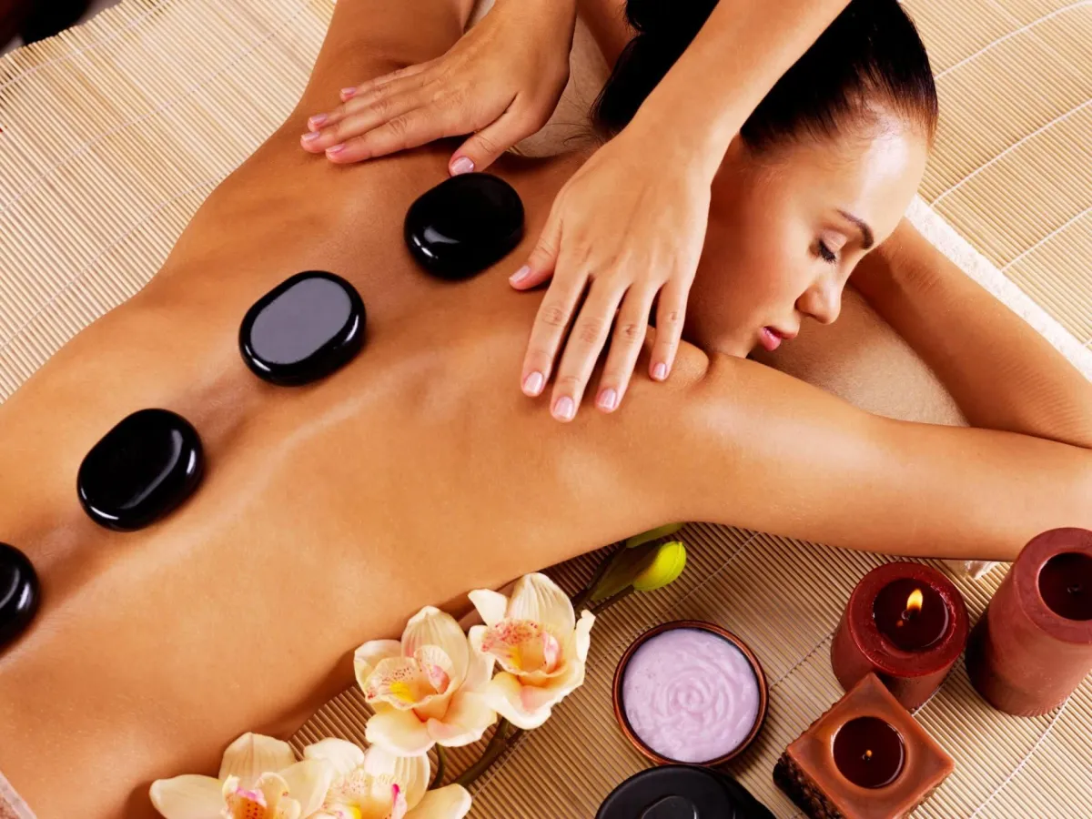 Hot stones placed on client’s back during massage at K Spa in Bellevue