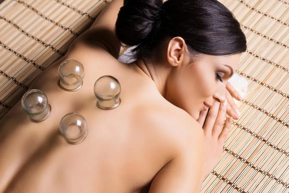 Client receiving cupping therapy on upper back at K Spa in Bellevue