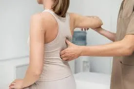 Therapist applying pressure to shoulder trigger point at K Spa in Bellevue