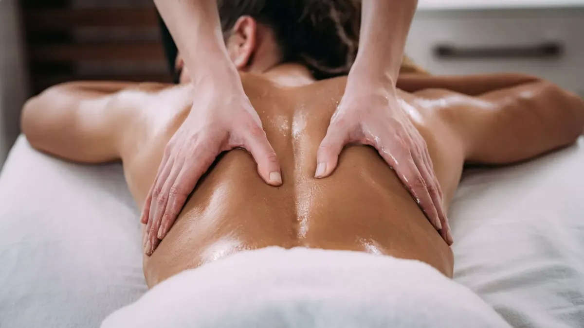 K Spa massage room prepared for therapeutic treatment with warm lighting