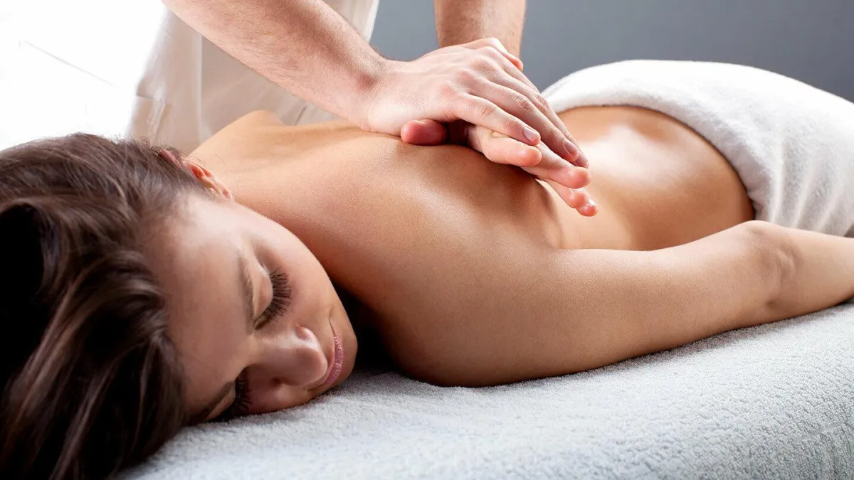 Therapist providing relaxing Swedish-style massage across entire body