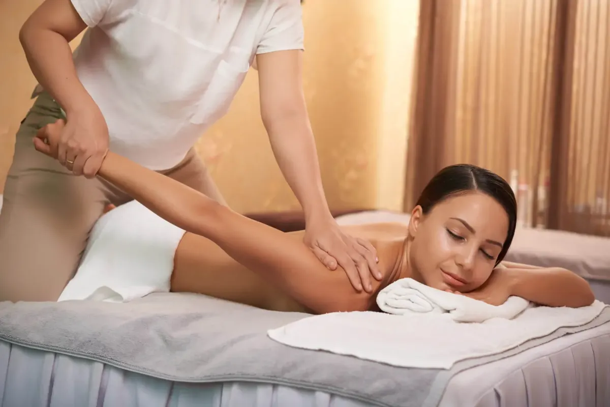 Therapist guiding assisted stretches during Thai massage