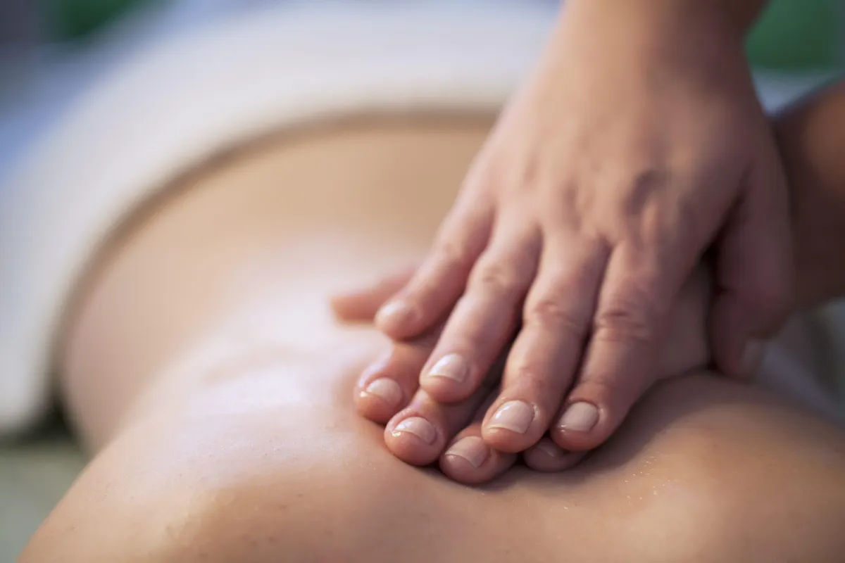 Therapist performing gentle lymphatic massage after surgery
