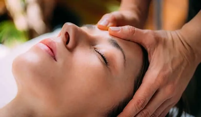 Therapist massaging neck and scalp for headache relief
