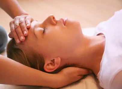 Gentle pressure applied to temples during migraine massage
