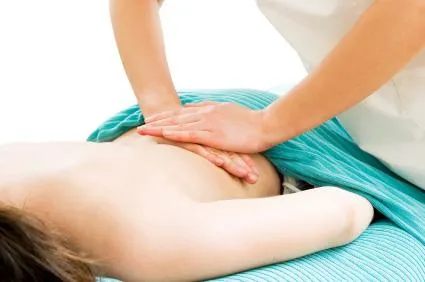 Massage therapist relieving lower back tension at K Spa